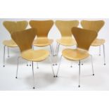 A set of six contemporary plywood stacking chairs on silvered-metal legs.