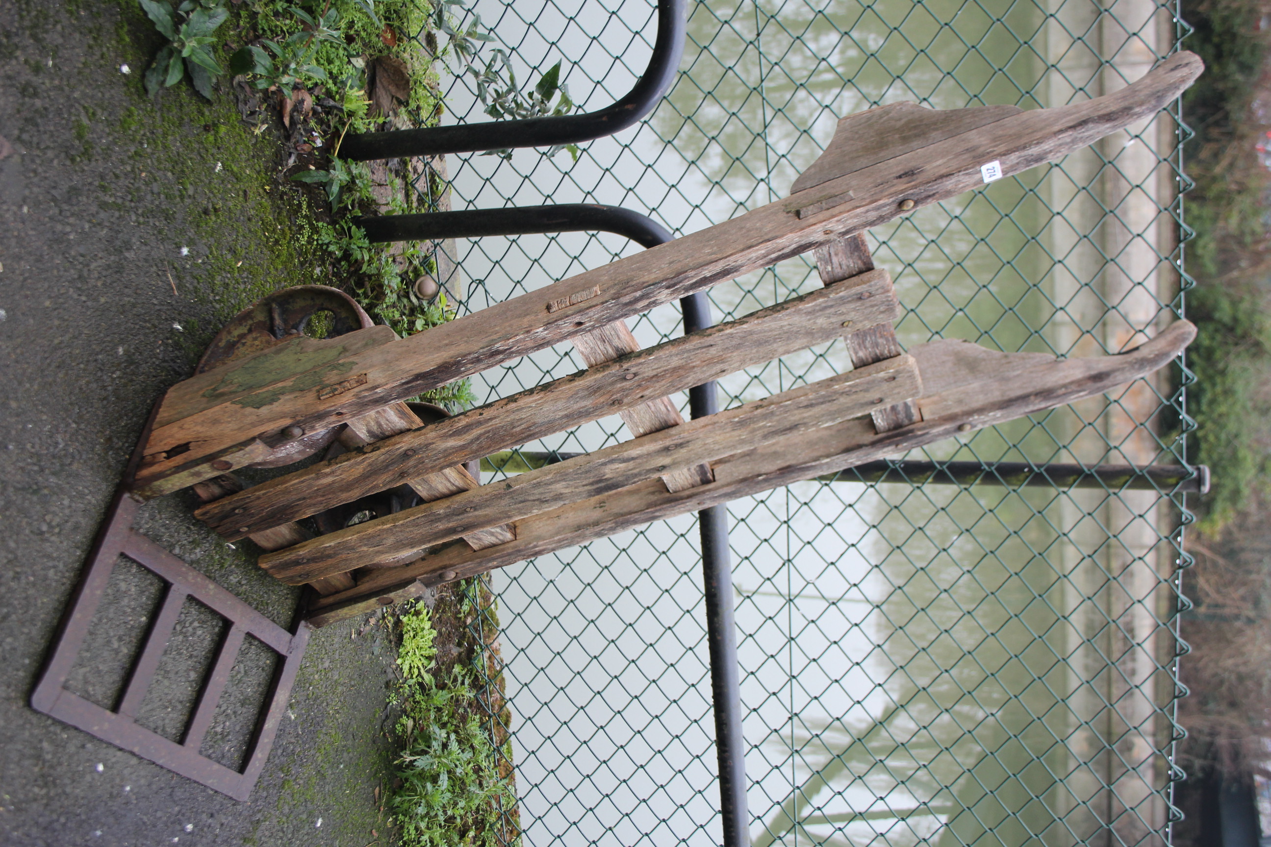 A large pair of early 20th century railway platform sack trucks.