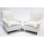 A pair of late Victorian square-back easy chairs upholstered white material & on short turned