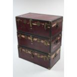 Three early-mid 20th century crimson-finish travelling trunks, each 36” wide (slight faults).