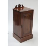 A Victorian mahogany pot cupboard fitted centre shelf enclosed by fielded panel door, & on plinth