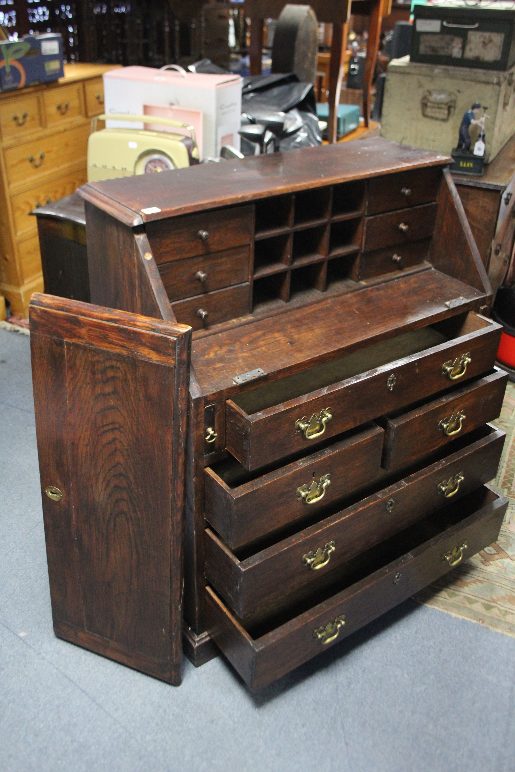 A 19th century oak bureau with fitted interior enclosed by fall-front above an arrangement of - Image 2 of 3