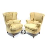 A pair of 19th century-style tub-shaped armchairs upholstered gold stamped velour, & on short carved