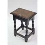 An 18th century-style oak joint stool on baluster-turned legs & turned feet with plain stretchers,