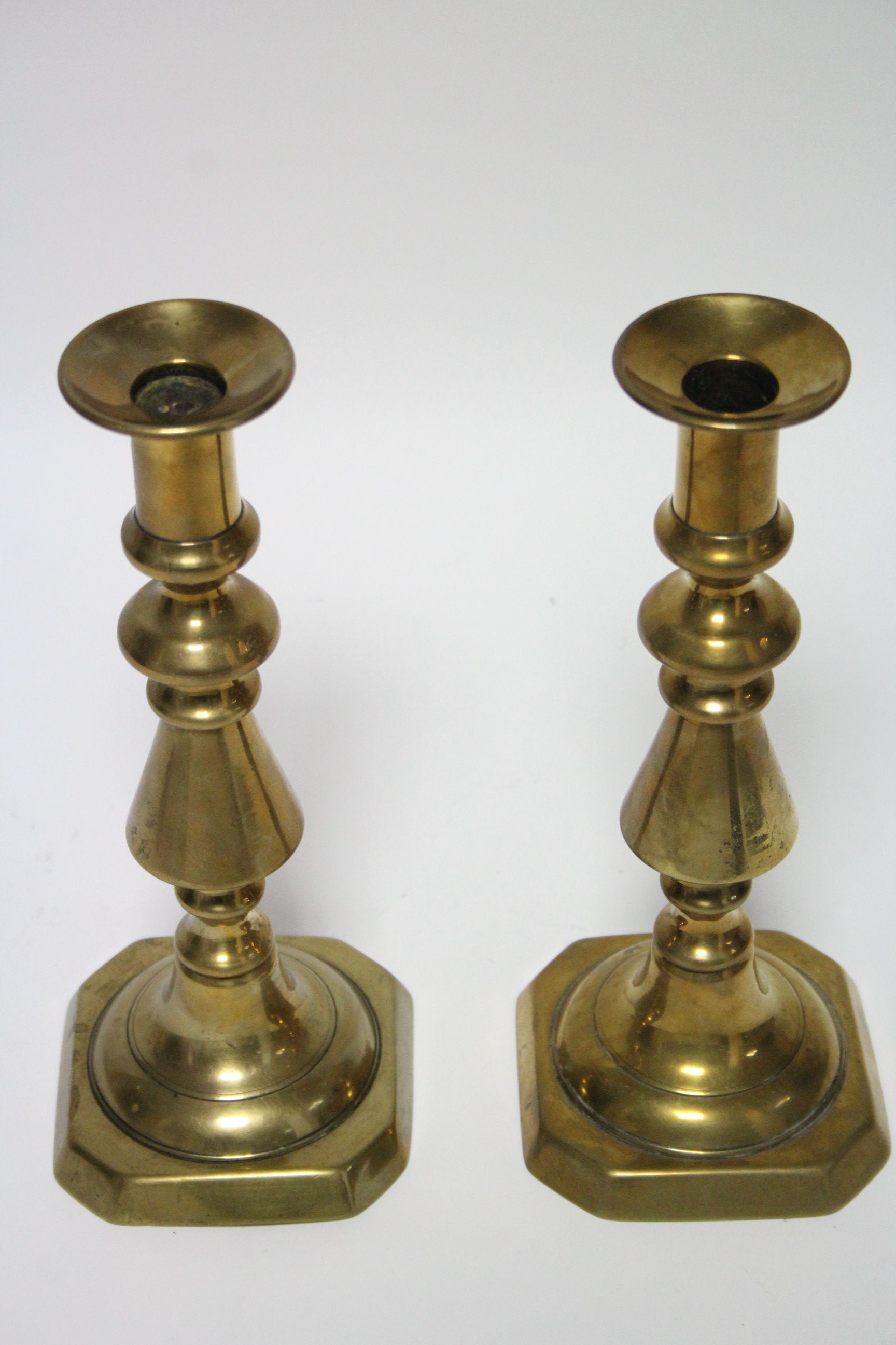 A pair of late 19th/early 20th century brass candlesticks, on turned tapering columns & square - Image 2 of 3