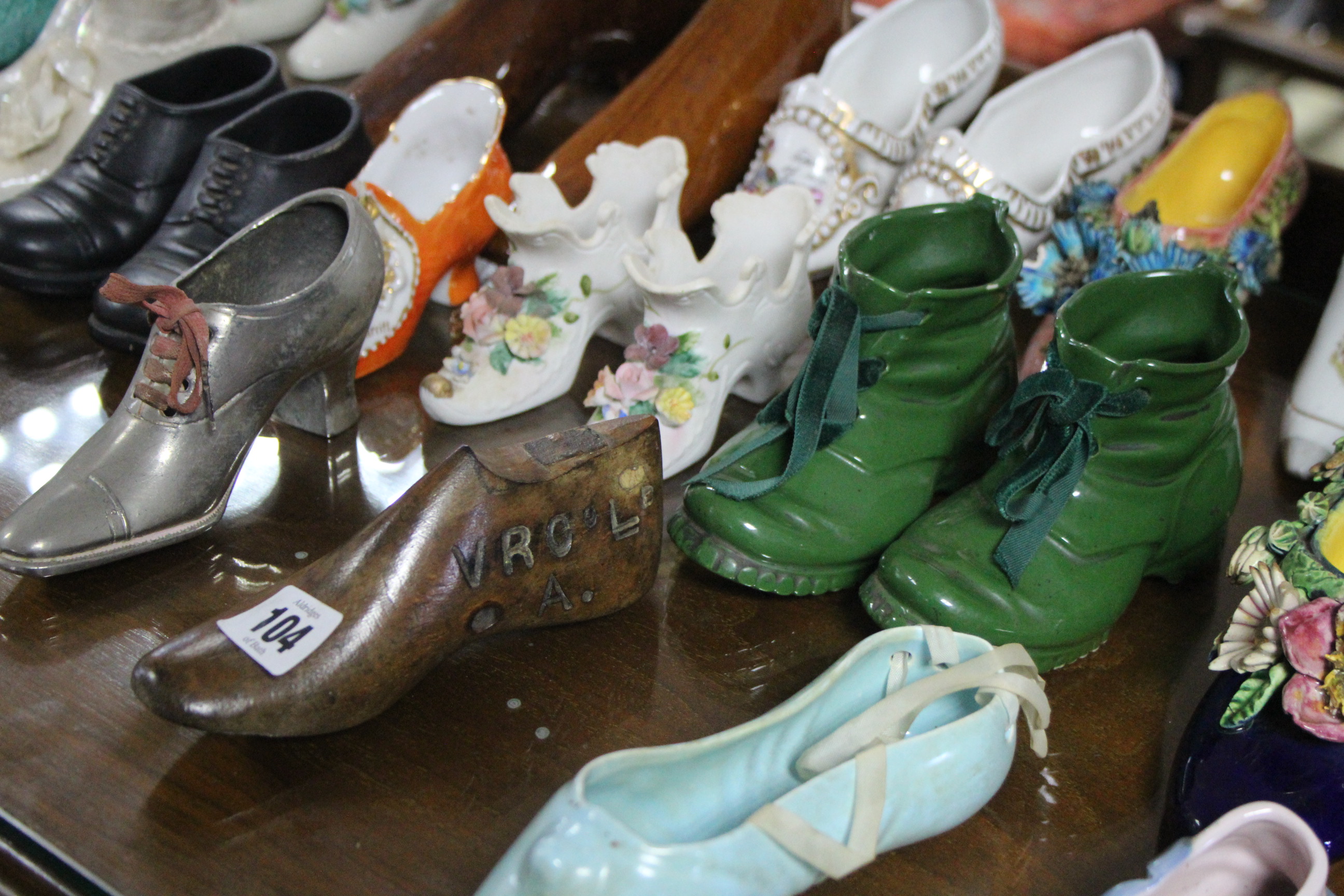 A collection of approximately forty various shoe ornaments.