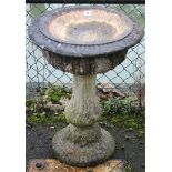 A reconstituted stone birdbath on round pedestal foot, 20” diameter x 26” high.