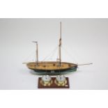 A painted wooden model sailing boat, 26½” wide; & a Mapro combination wall clock & barometer mounted