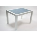 A pale blue painted wooden writing table inset blue vinyl to the rectangular top, & on square