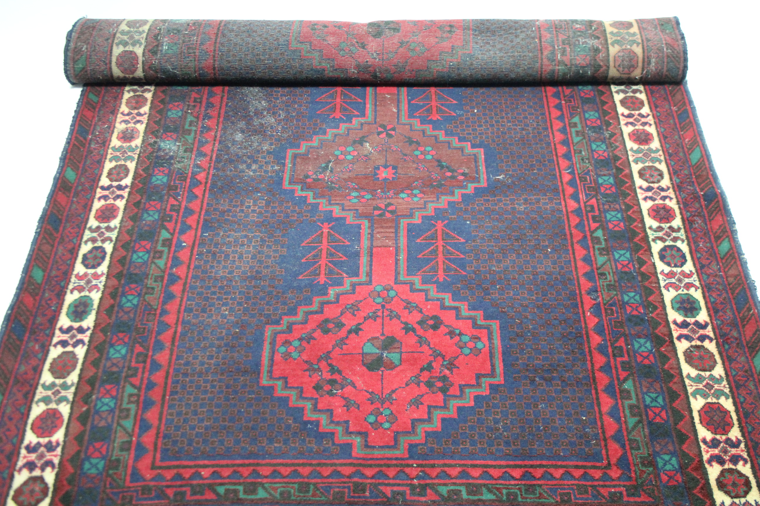 A Persian pattern small carpet of crimson deep blue ground, with geometrical design to centre within - Image 2 of 3