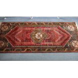 A Persian pattern large rug of crimson & ivory ground, with geometric design to centre within a wide