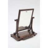 A 19th century mahogany rectangular swing toilet glass with scroll supports, & on break-front