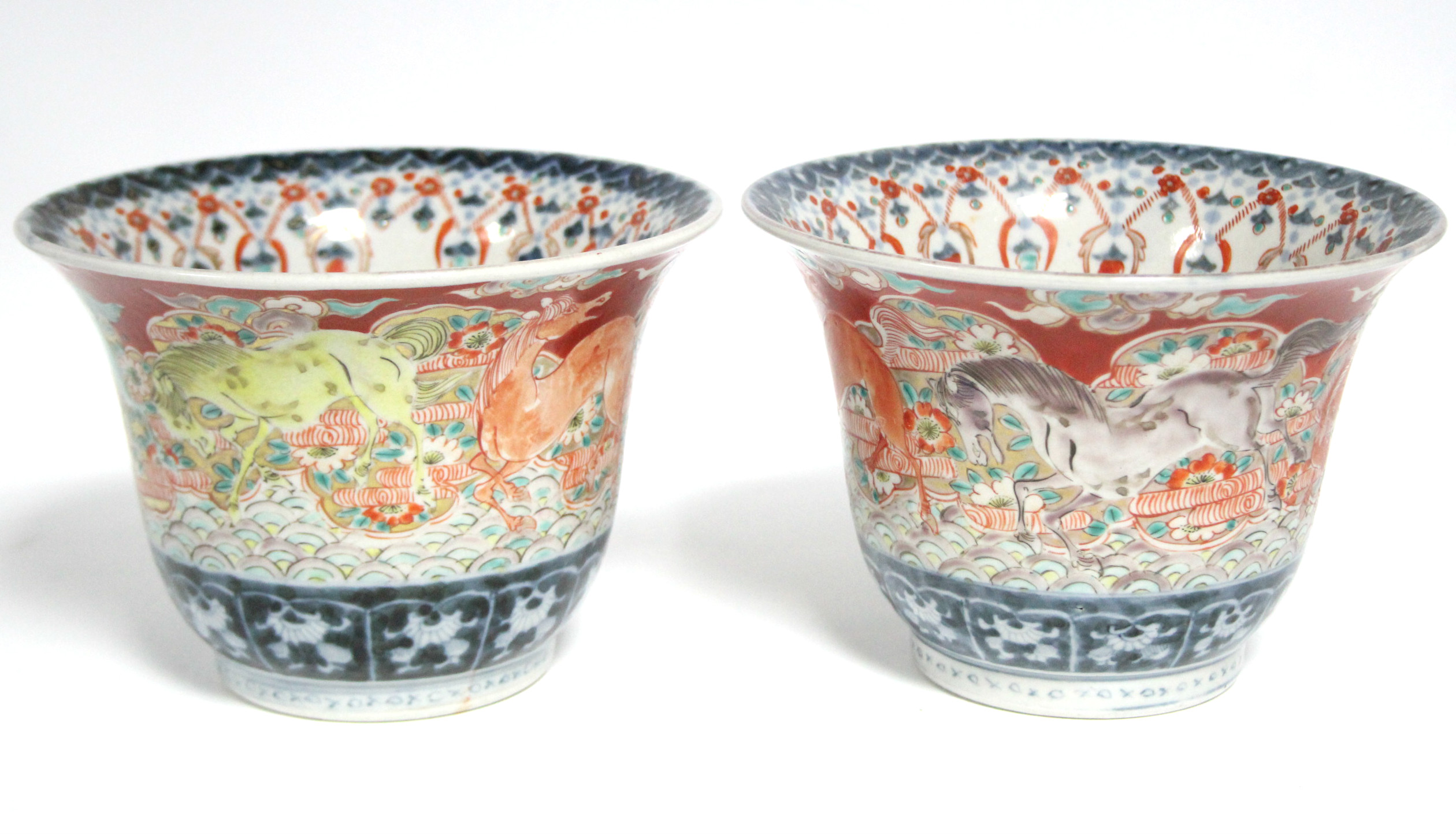 A pair of late 19th century Japanese Imari porcelain vases of rounded form with flared rims, the