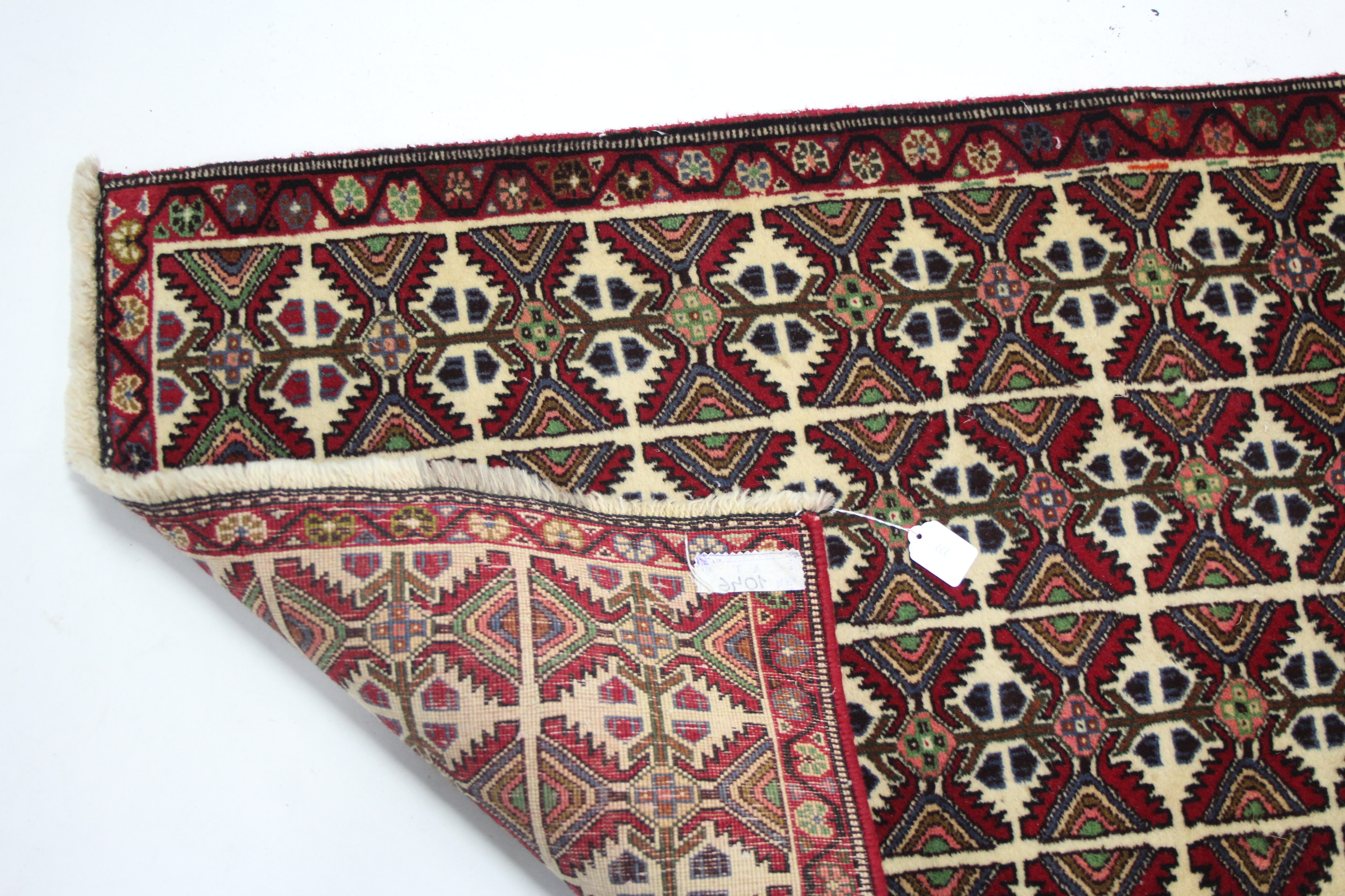 A modern Persian rug of ivory ground with all-over repeating multi-coloured geometric pattern; 6’ 2” - Image 2 of 2