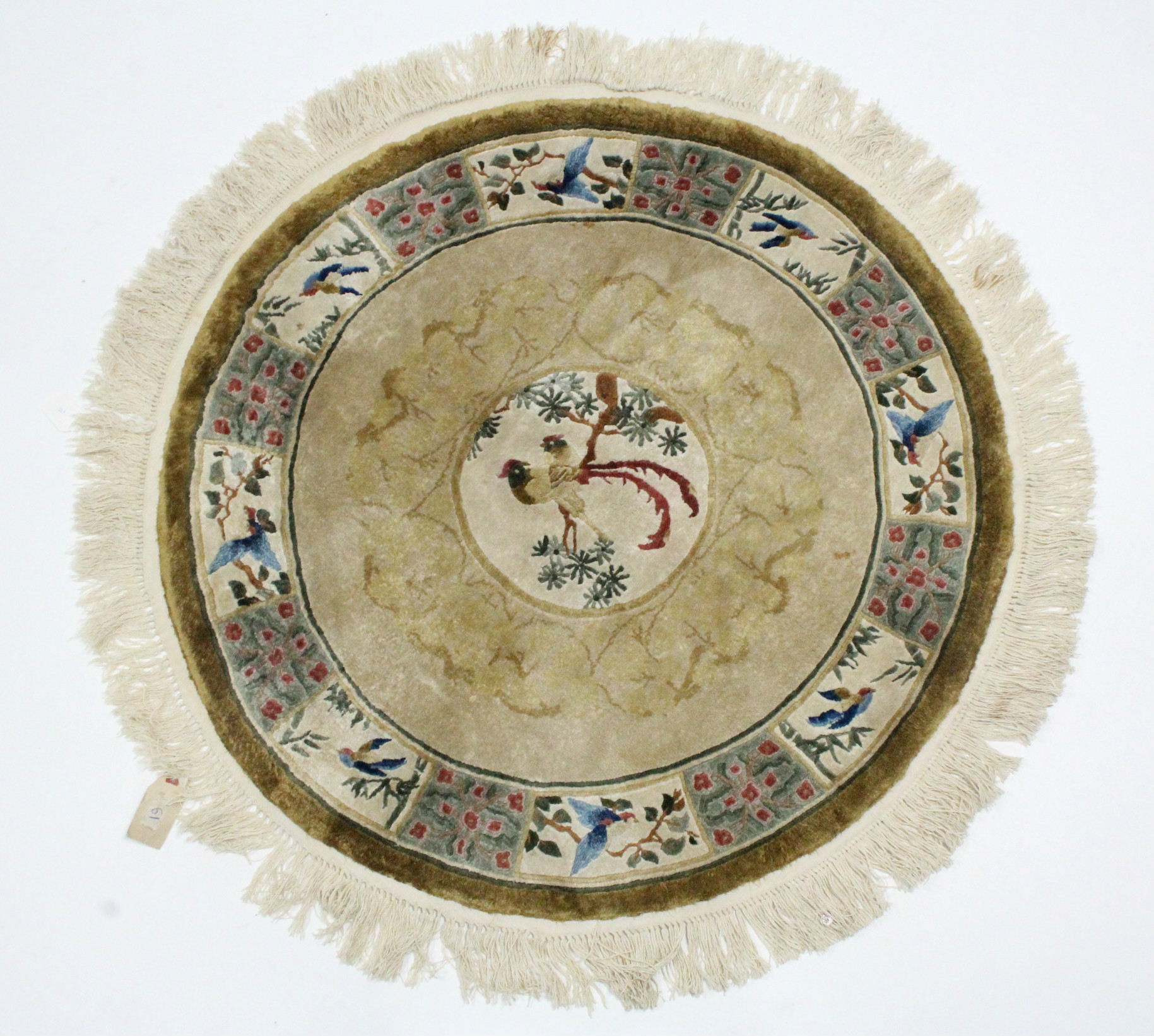 A Chinese silk circular rug with coloured decoration of birds on a fawn ground; 36” diam.