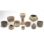 Four ancient middle-eastern pottery small cylindrical vessels with painted geometric decoration, the