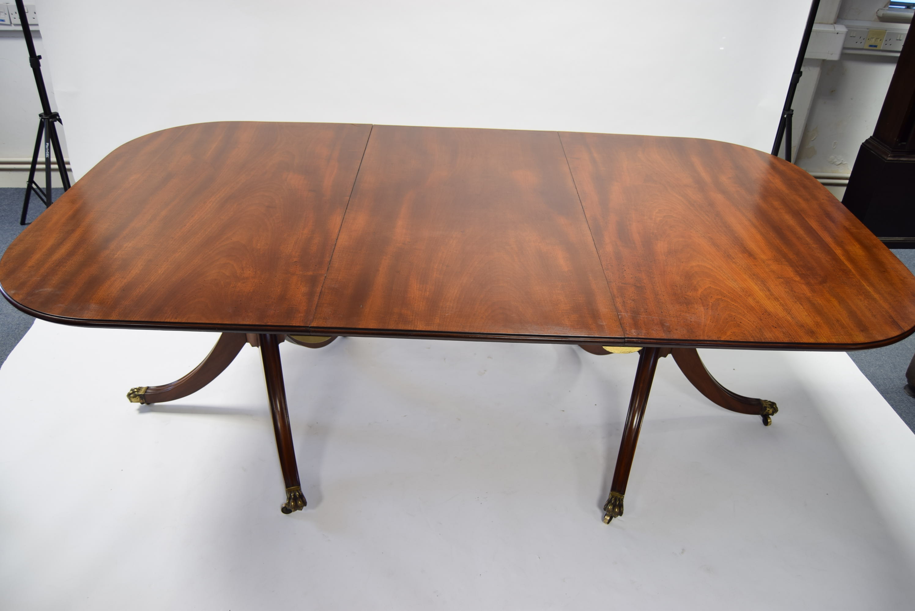 A Regency-style mahogany twin-pedestal dining table, the rectangular top with rounded corners, one - Image 2 of 3