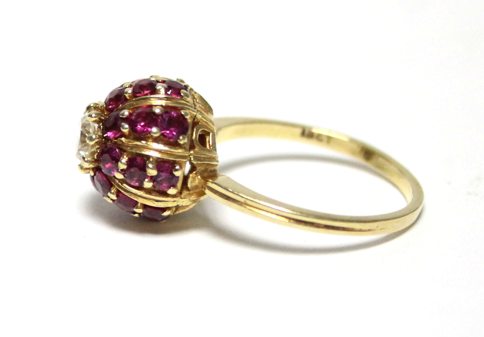 An 18ct. gold ring, the domed head set twenty four small rubies, & central diamond of approx. 0. - Image 4 of 4