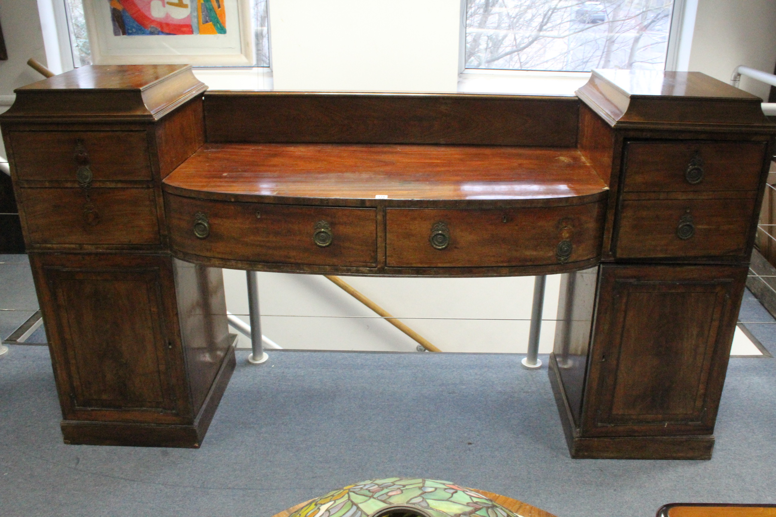 A regency mahogany pedestal sideboard, the centre fitted two drawers, a cellarette drawer above a