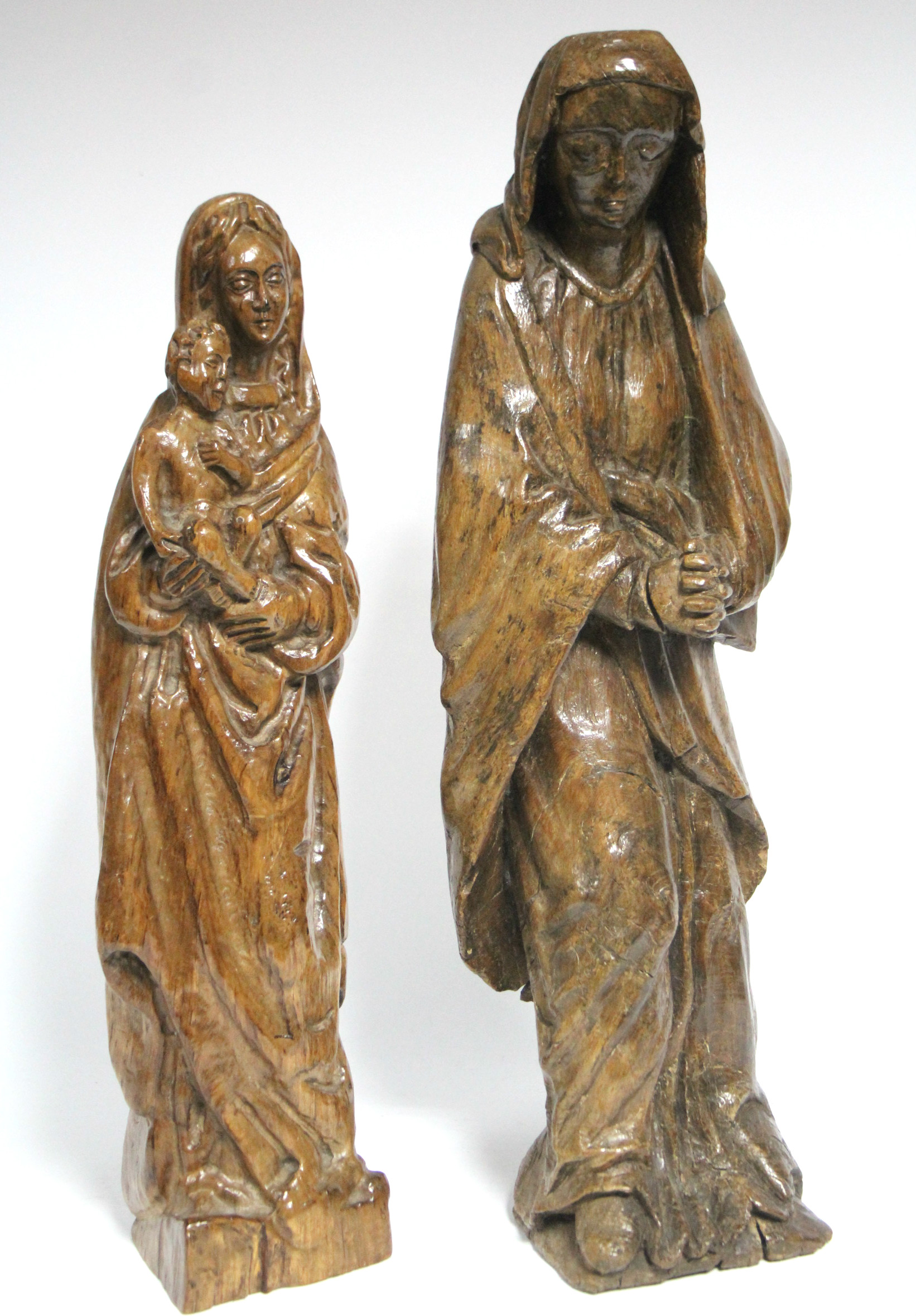 A carved oak standing figure of the Virgin Mary, 19¼” high; & another carved wood figure of the