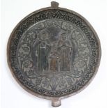 A carved wood large circular shallow bowl with relief decoration of the Holy Family to the centre