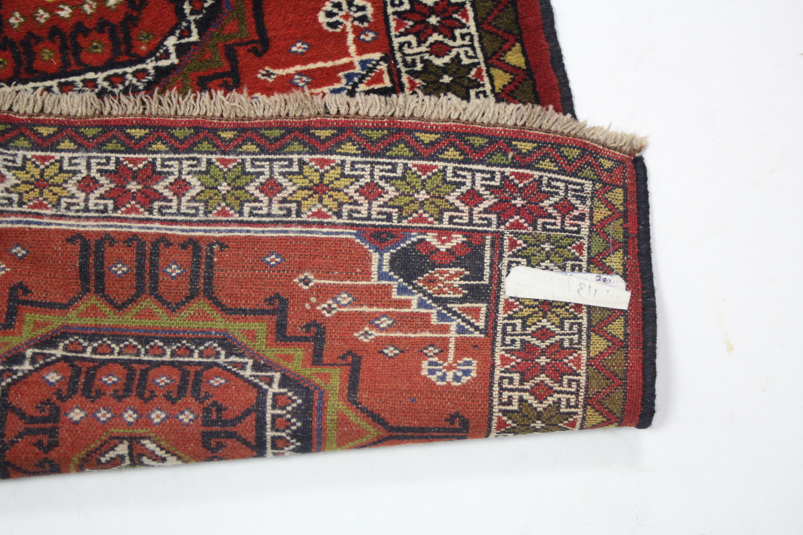 A modern Persian corridor runner with row of six multi-coloured panels on a coral-red ground; 9’ 10” - Image 2 of 2