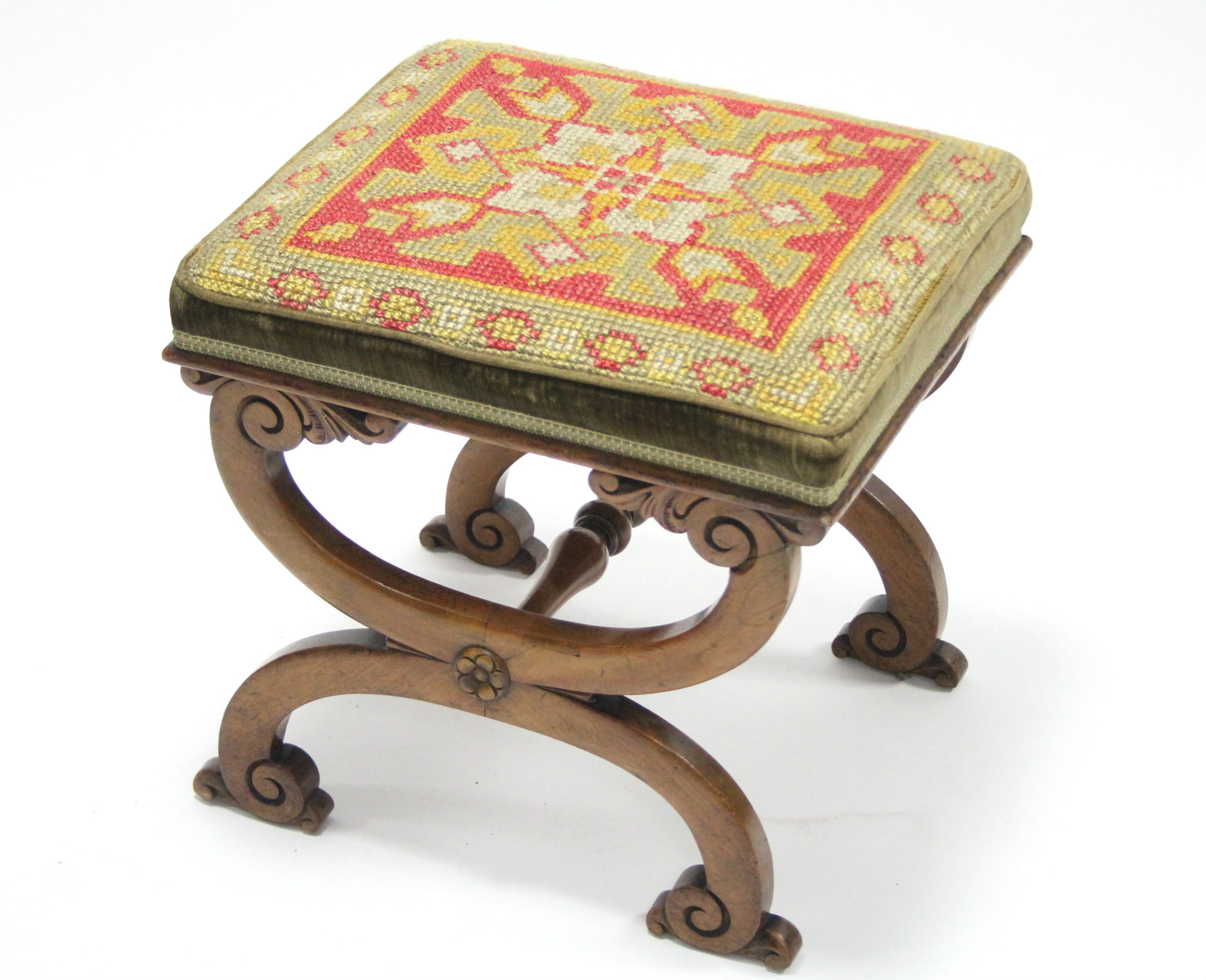 An early Victorian walnut rectangular foot stool, on curved X supports with turned centre stretcher,