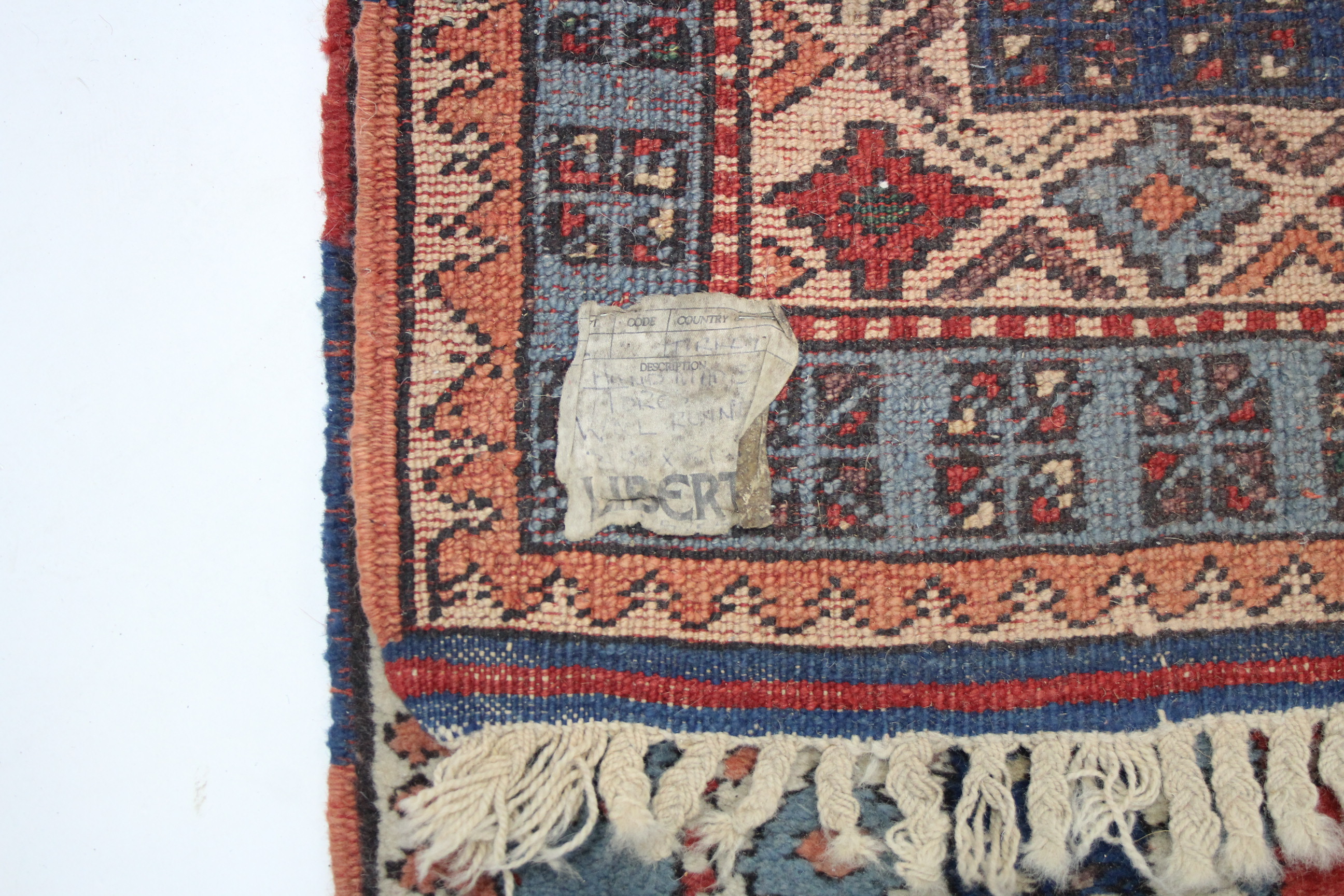 A Turkish corridor runner retailed by Liberty, of crimson ground with two rows of repeating herring - Image 3 of 4