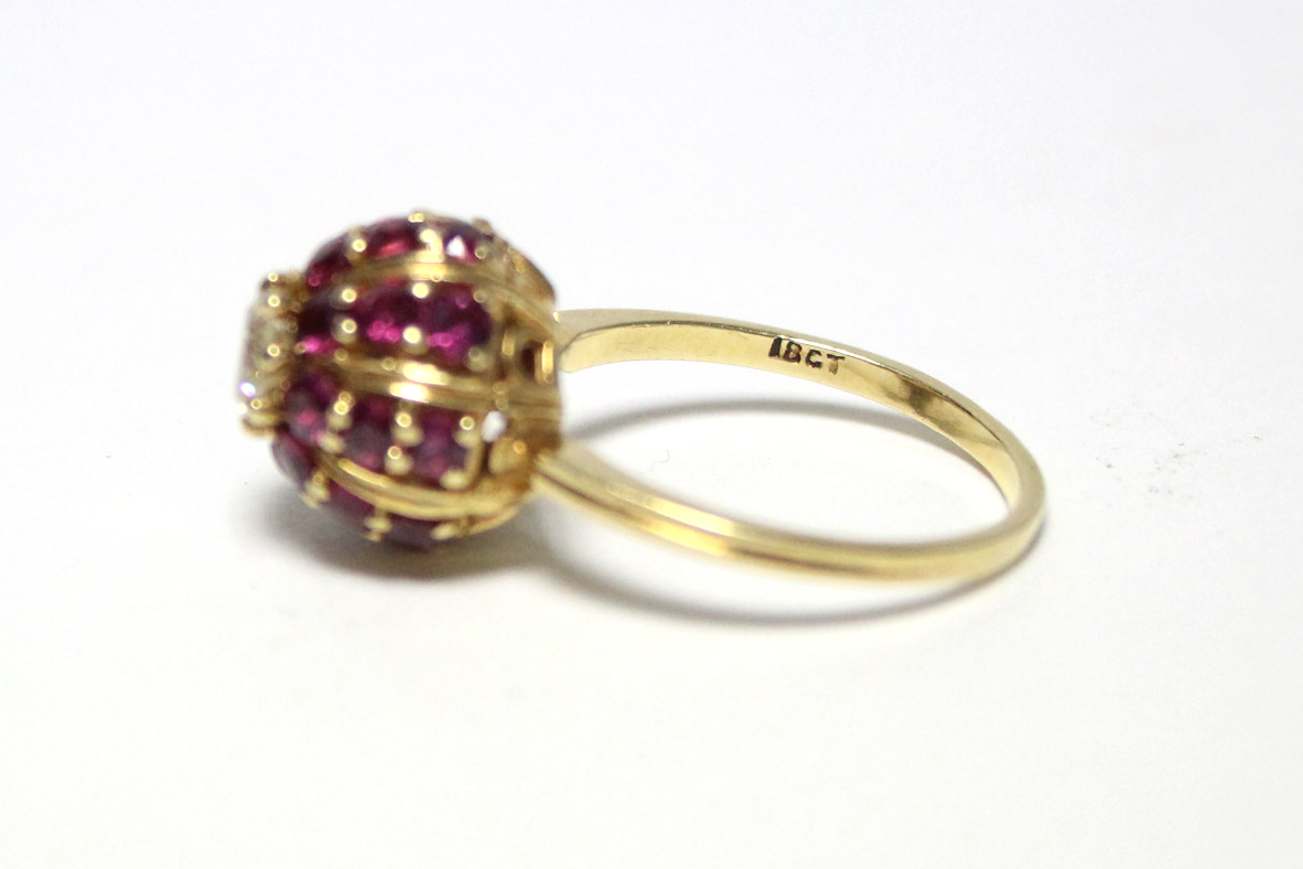 An 18ct. gold ring, the domed head set twenty four small rubies, & central diamond of approx. 0. - Image 3 of 4