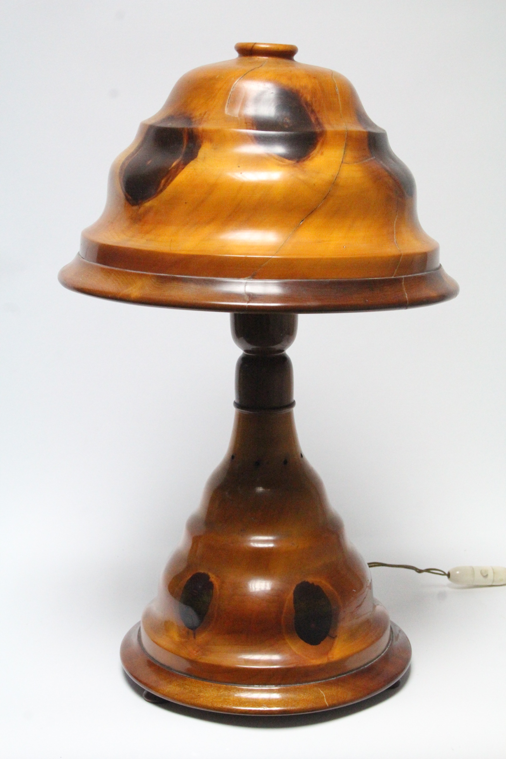 An early 20th century Palm-wood table lamp with domed shade, on turned flared base; 19” high.