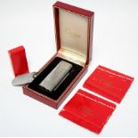 A Cartier pocket cigarette lighter in white metal “Brushed Florentine” case; in original box, with