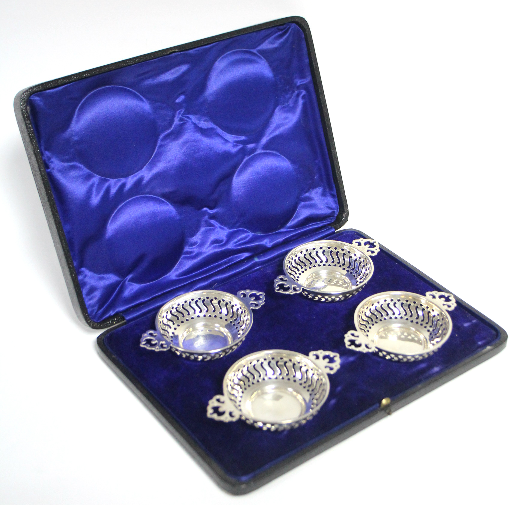 A set of four Quaich-shaped sweetmeat dishes with pierced decoration to the sides & the flat