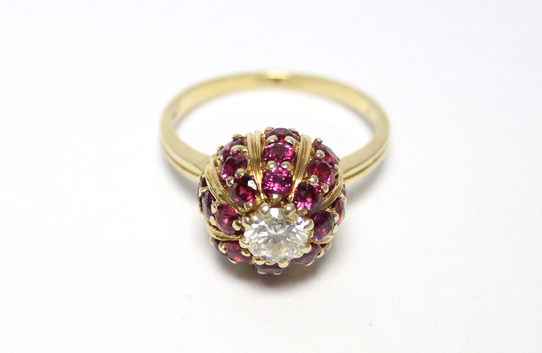 An 18ct. gold ring, the domed head set twenty four small rubies, & central diamond of approx. 0. - Image 2 of 4