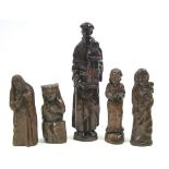 A carved wood standing figure of a male saint, 26¾” high; & four smaller carved wood religious