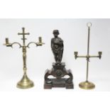 Two ecclesiastical brass twin-branch candelabra, 18½” & 17¼” high; & a bronze andiron with