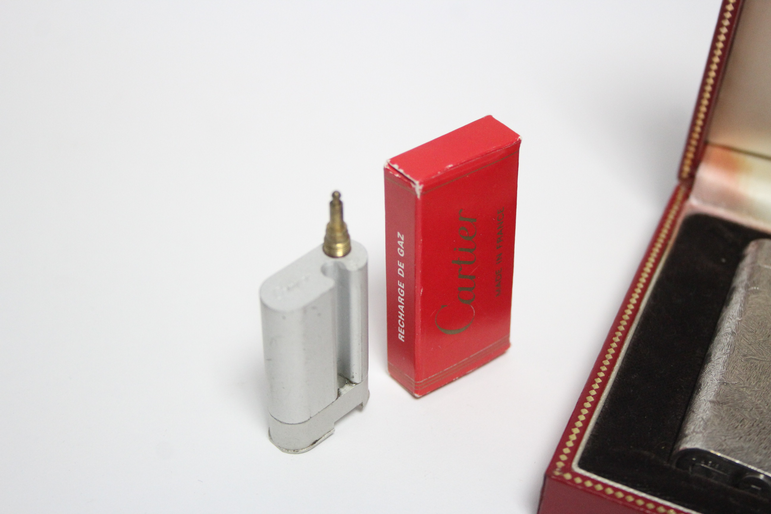 A Cartier pocket cigarette lighter in white metal “Brushed Florentine” case; in original box, with - Image 4 of 4