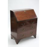 An Edwardian inlaid-mahogany small bureau with fitted interior enclosed by fall-front above three