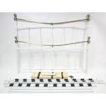 A white-finish metal & brass double bedstead of tubular form, 63” wide, with side rails.