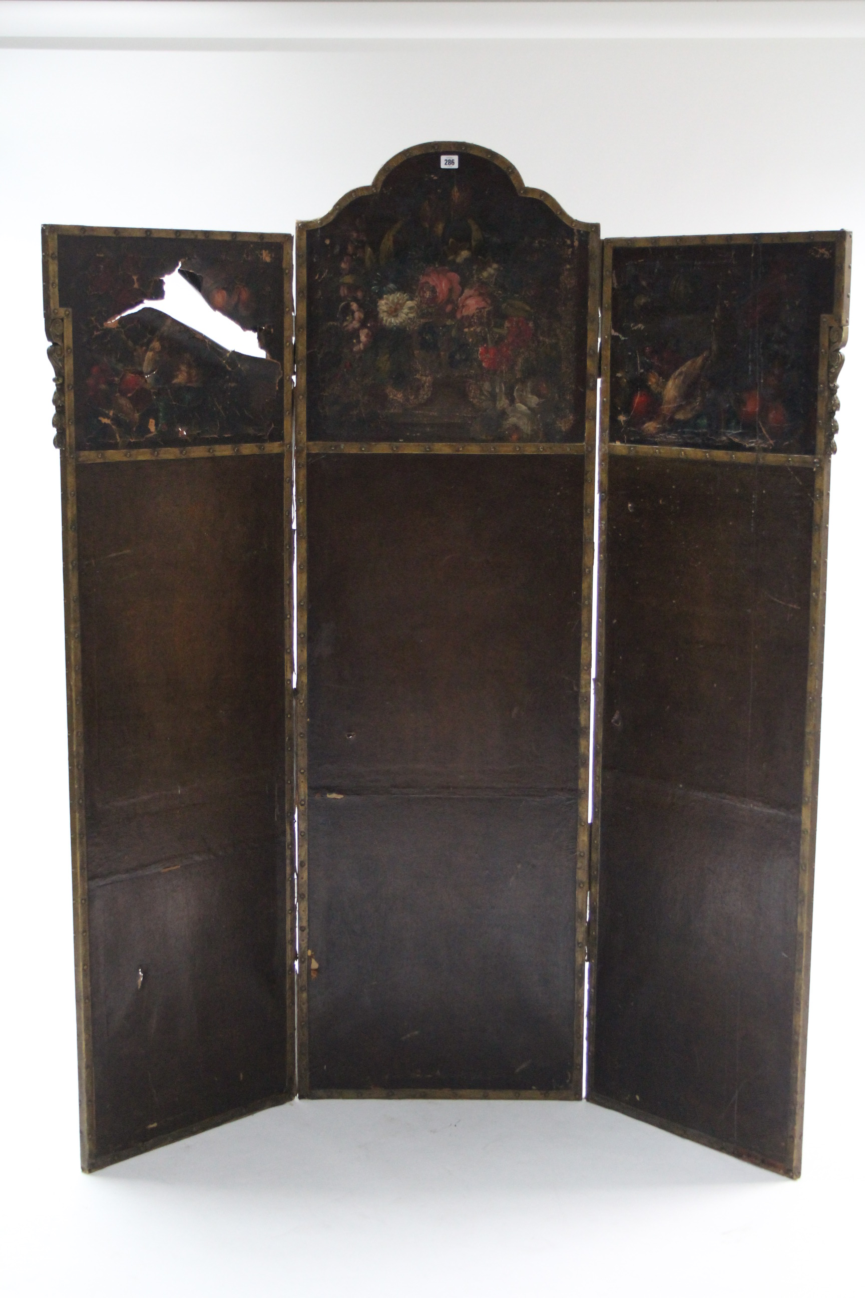 A late 19th/early 20th century brass studded & carved wooden frame three-fold draught screen with