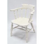 A late 19th/early 20th century white painted wood spindle-back captain’s chair with hard seat, &