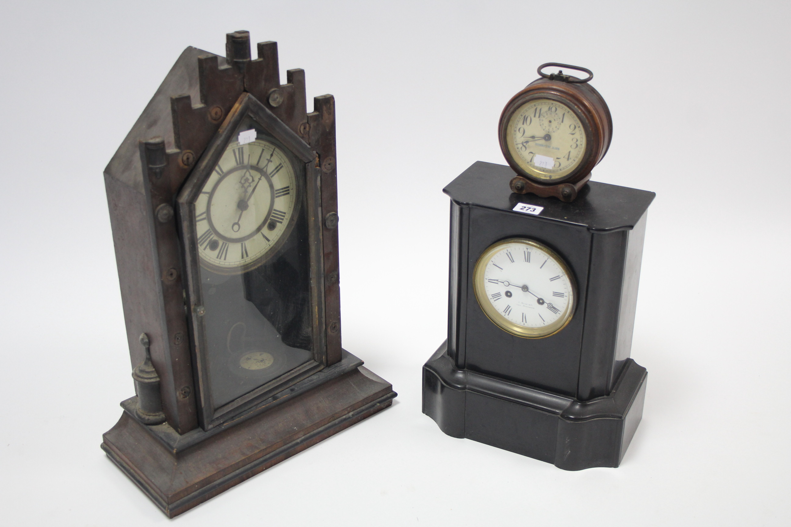 A 19th century mantel clock with black roman numerals to the white enamel dial signed “HALL & Co.