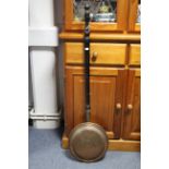 A copper warming pan with long turned wooden handle, an eastern copper engraved tray, a small wall