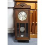 A mid-20th century wall clock with round silvered dial, & in oak case, 30” high; together with a