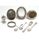 A silver pepper pot (hallmarks rubbed); a silver oval photograph frame; a pair of sterling silver