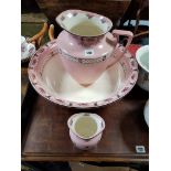 A Stuart Border Burslem toilet jug, basin & toothbrush vase, of pink ground & with rose