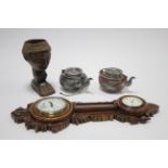 An early 20th century aneroid wall barometer/timepiece, with white enamel dial, and in carved oak
