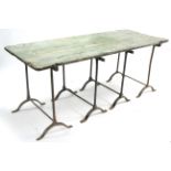 A mid-20th century painted pine trestle table on four iron supports, 72” long.