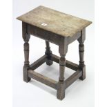 An oak joint stool with moulded edge to the rectangular seat, & on baluster-turned legs with plain