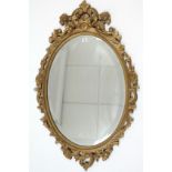 A 19th century-style large gold painted & carved wood frame oval wall mirror inset bevelled plate,