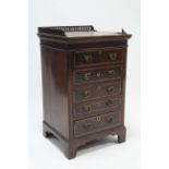 A 19th century inlaid-mahogany small chest with pierced gallery, fitted five long graduated